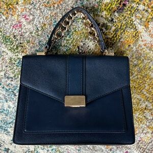 Brand new blue purse with strap and gold handle